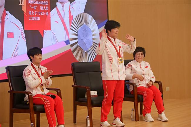 图为残奥会冠军刘立与现场师生热情打招呼